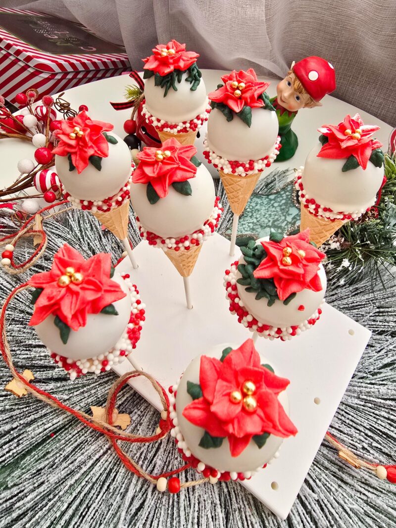 Poincettia christmas cake pops red green icecream cones detailed annyversary cake pop on a stand individually wrapped